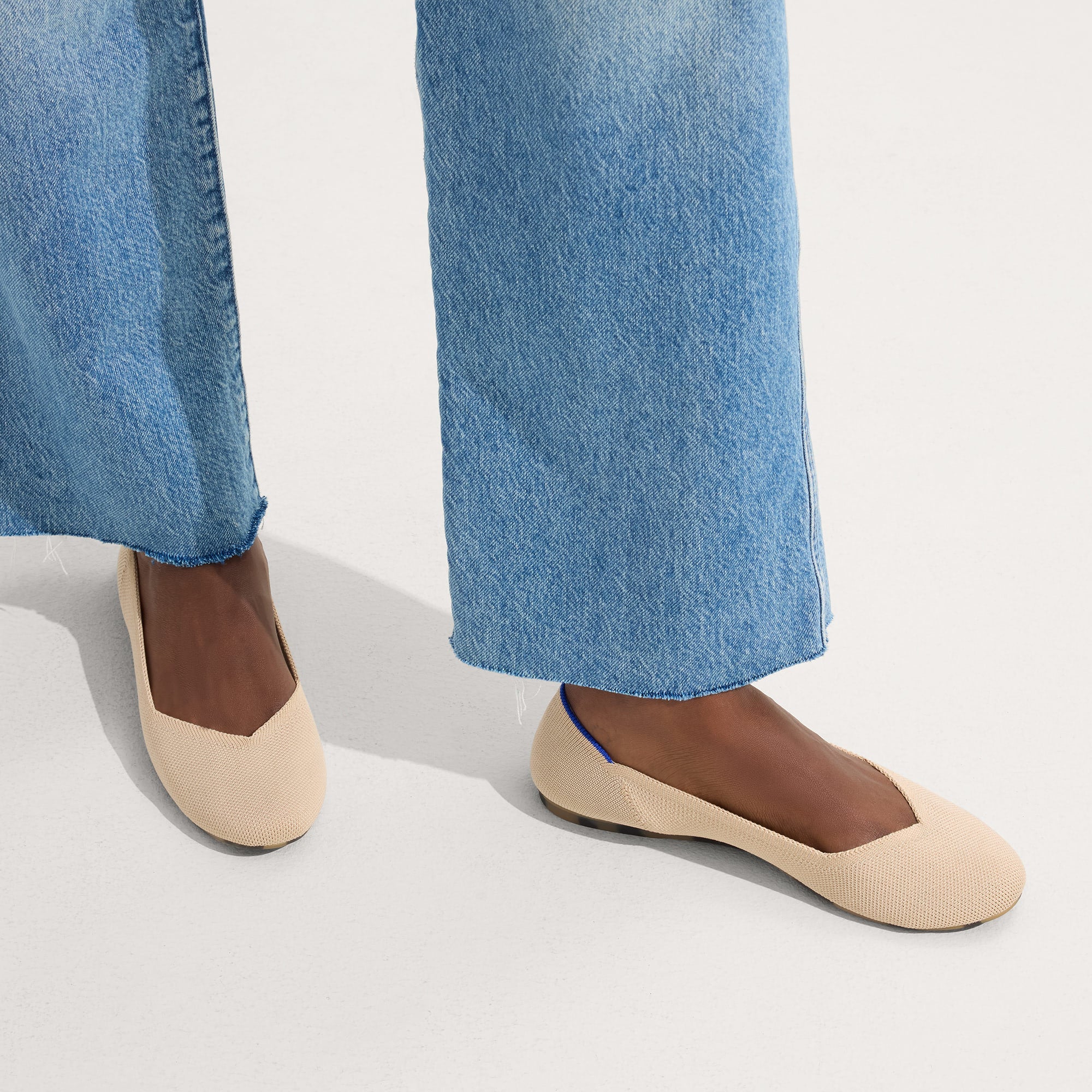 hover | The Flat round toe shoe in Ecru shown on-model at an angle.