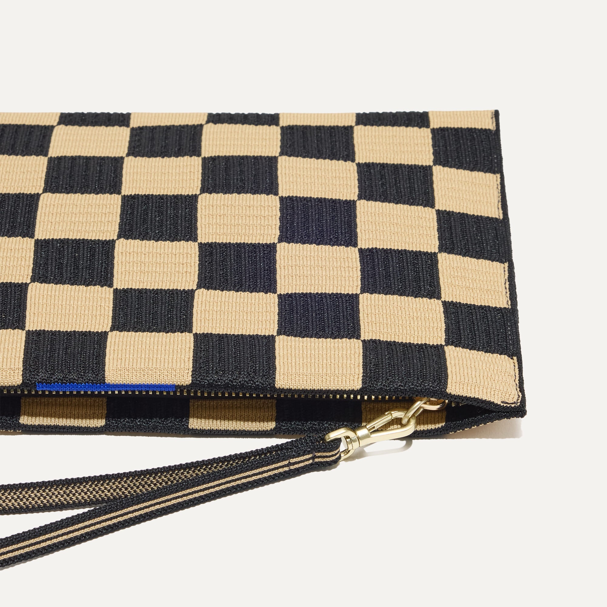 Close up of The Wristlet in Checker Classic with detachable wrist strap.