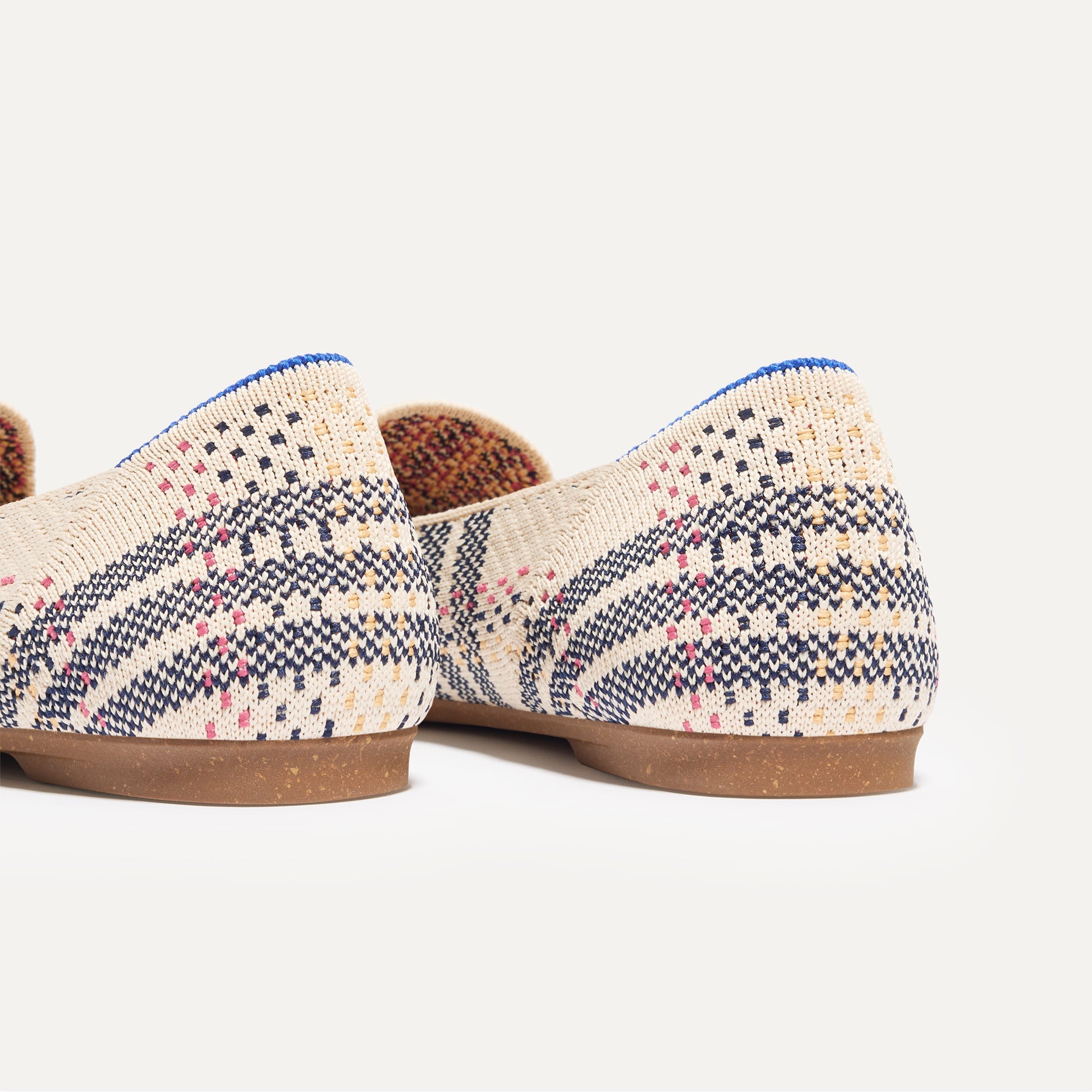 Close up of the heel of The Almond Tassel Loafer in Spring Plaid, with Rothy's signature blue halo. 